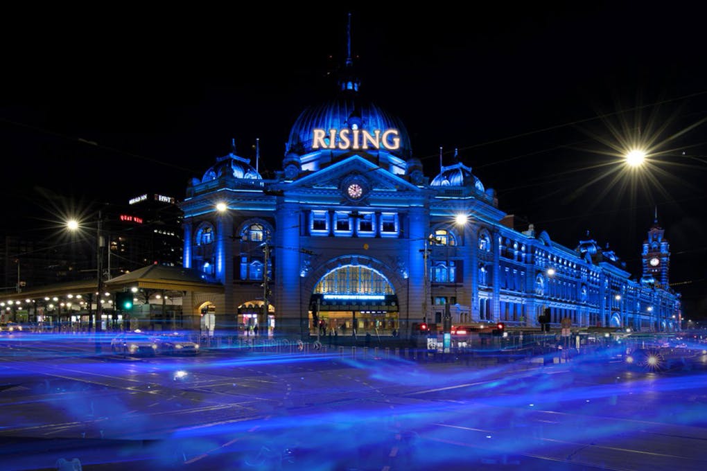 Federation square lit up in blue for Rising Festival Melbourne.